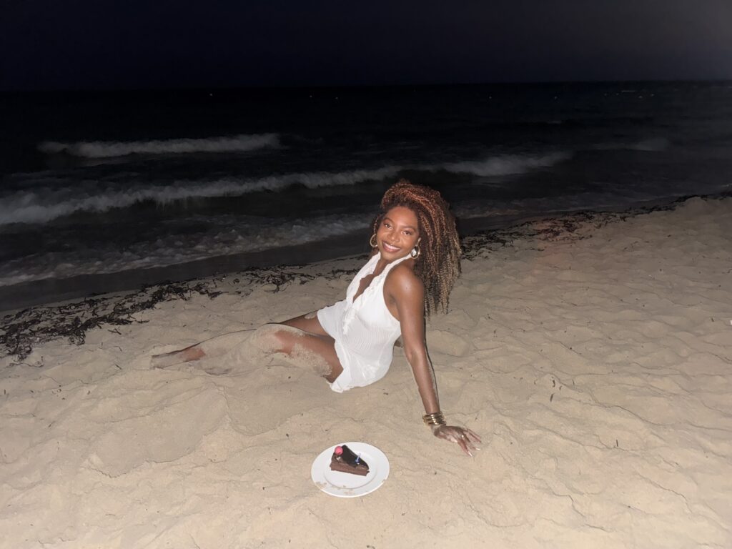 things I would tell my younger self - Metiya on the beach with cake